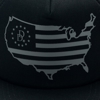 Black flat brim hat with a mesh back and a USA and flag outline with a Daniel Defense logo