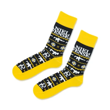 Black and Yellow socks written Daniel Defense in white at the top, and with several images of of firearms over the surface