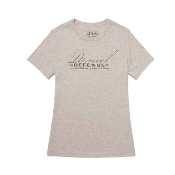 A light tan t-shirt with the text "Daniel Defense" printed in a script font across the chest. Below the name, the phrase "THE SECOND DEFENDS THE REST" is printed in smaller letters.